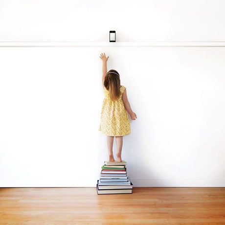 girl standing on books