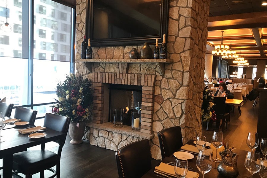The dual-sided fireplace at the new Seaport Tuscan Kitchen