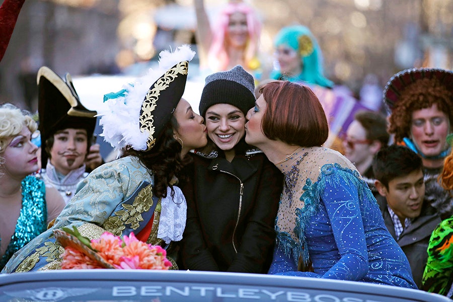 Actress Mia Kunis is kissed by actors dressed in drag during a parade for Kunis in Cambridge, Thursday, Jan. 25, 2018. Kunis was honored as "Woman of the Year" by the Hasty Pudding Theatricals at Harvard University.