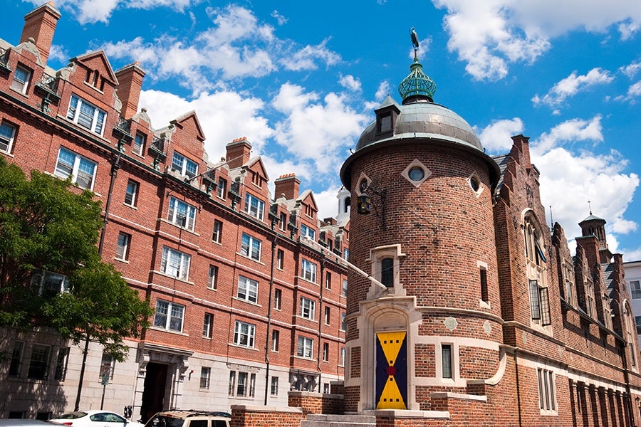 A brick building in Cambridge with a blue and yellow door