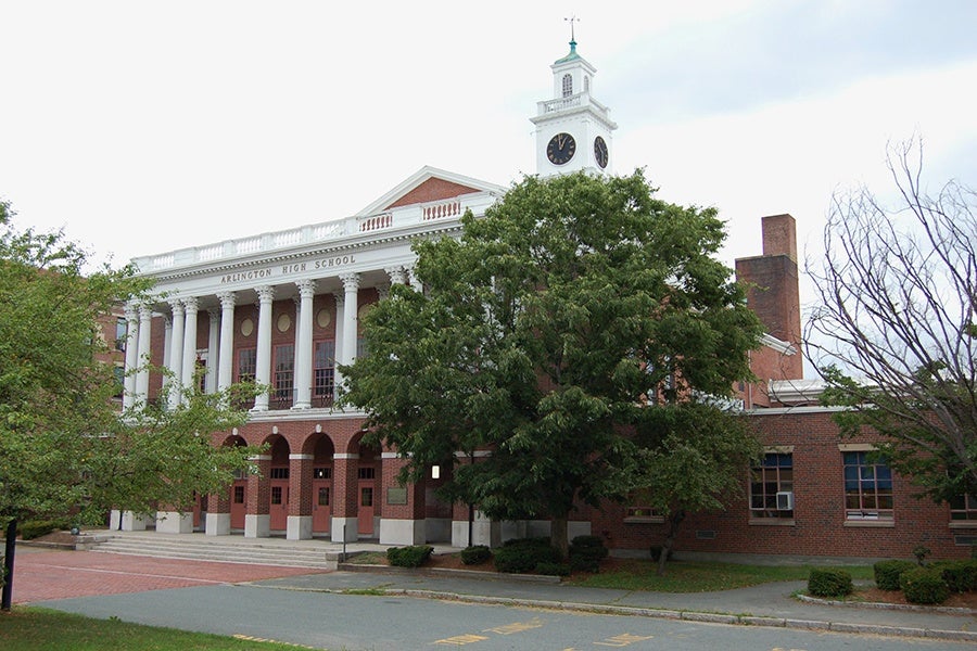 A stately brick building with a clock tower and columns