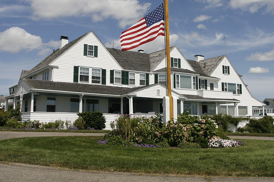 A beautiful home with an American flag in front of it