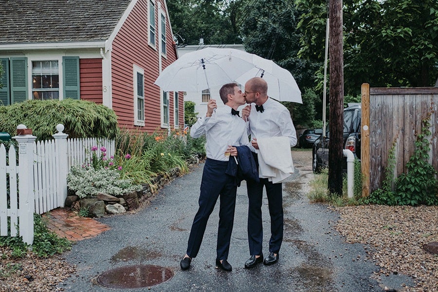 couple kisses under an umbrella