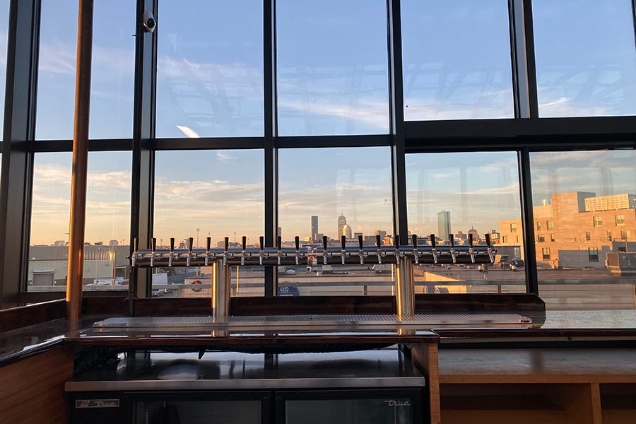 The rooftop beer hall at Dorchester Brewing Company boasts beautiful Boston skyline views