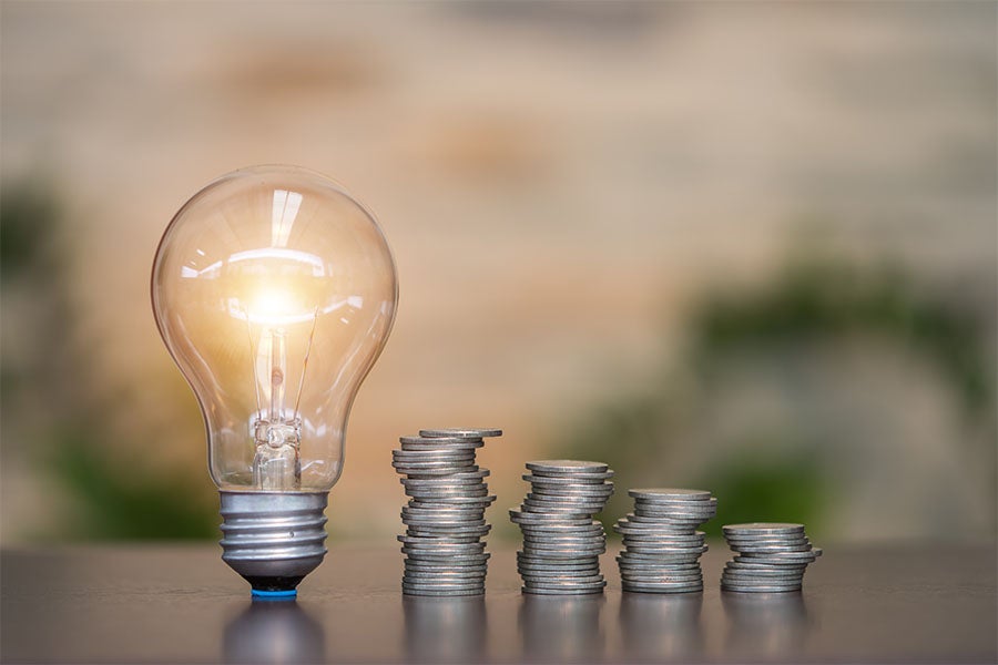 light bulb and stacks of change
