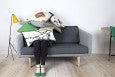 woman hiding under pillows