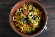 Overhead view of yellow rice studded with seafood and chorizo.