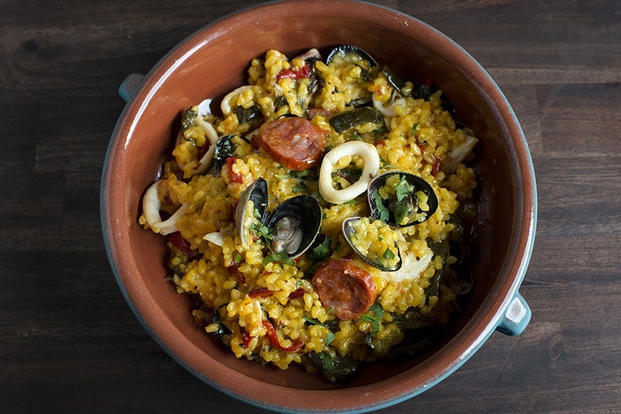 Overhead view of yellow rice studded with seafood and chorizo.