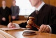 Judge holding gavel in courtroom