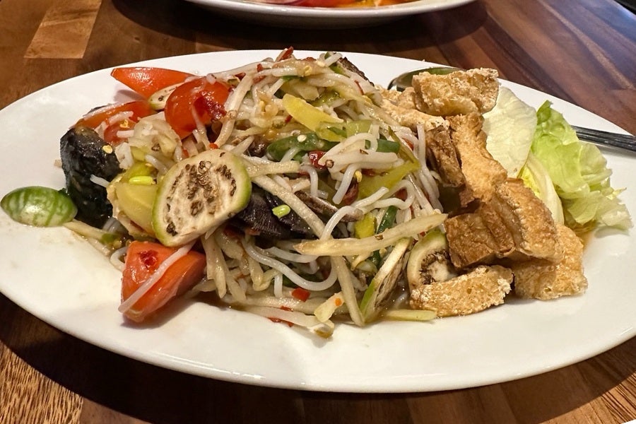 A Thai papaya sala with tomatoes, small Thai eggplants, and more.