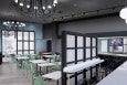 Rendering of a somewhat casual sit-down restaurant with bar space and minimalist decor, featuring light blue and light green accents.