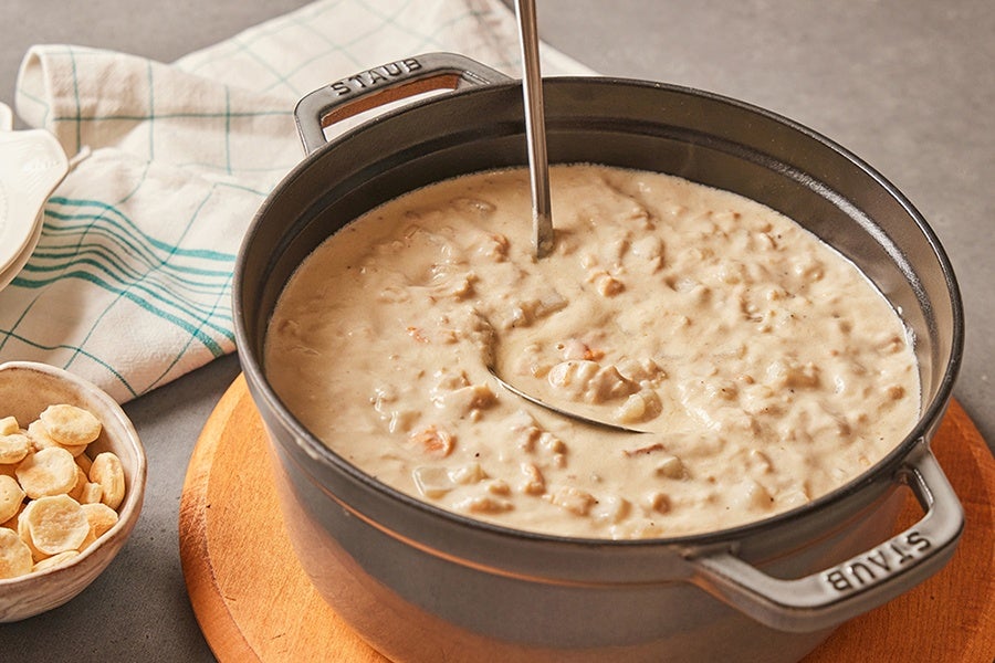 A Staub pot is full of thick clam chowder