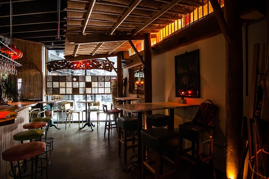 A small restaurant space features an outdoor-style roof overhang made of bamboo.