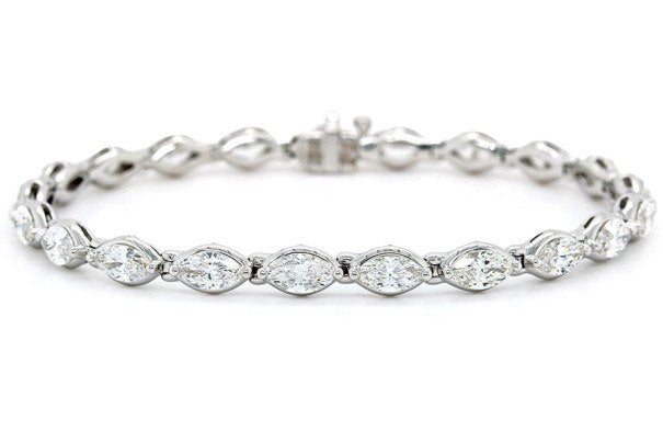 Available at Long's Jewelers: Long's Signature Collection 18-karat-white-gold bezel-set marquise diamond tennis bracelet, price upon request.
