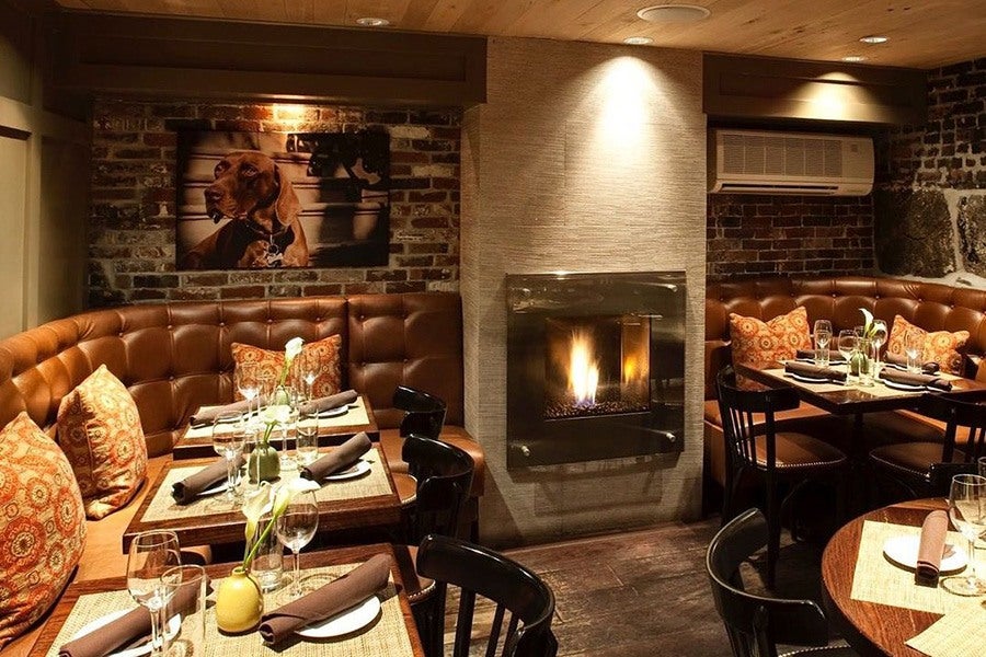 South End Buttery's downstairs dining room with a lit fireplace.