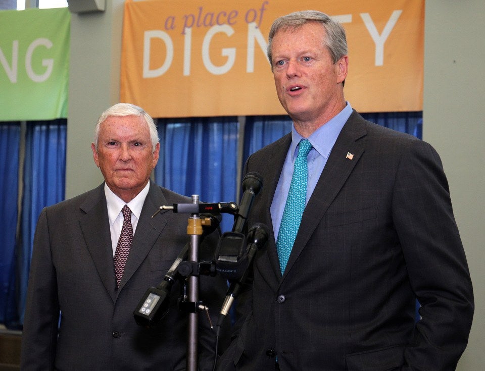 A photo of Jack Connors, a white-haired gentleman in a suit and tie, beside Massachusetts governor Charlie Baker, in a blue tie and suit.