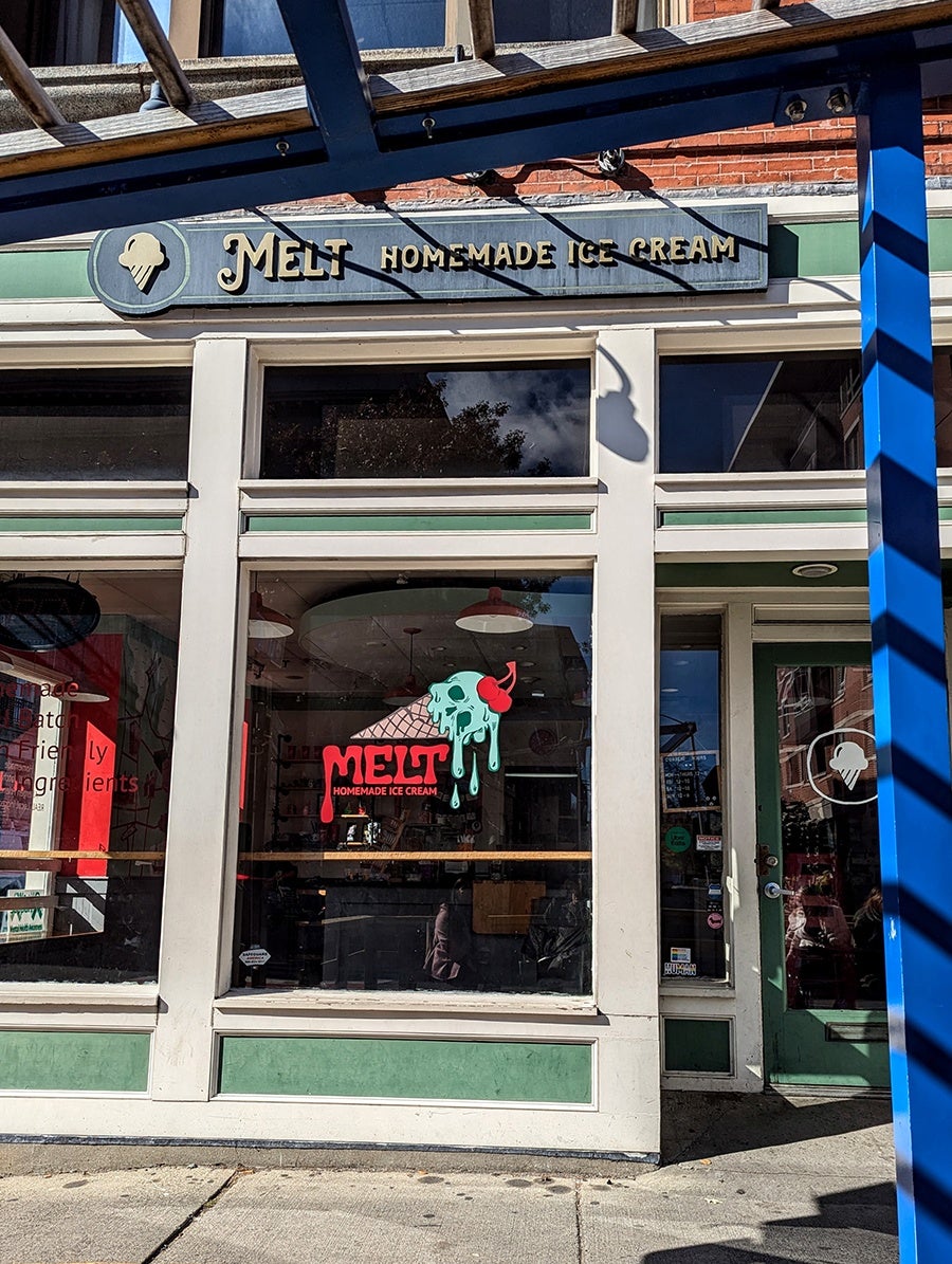 Exterior of an ice cream shop with a Halloween-themed logo featuring an ice cream scoop that looks like a skull.