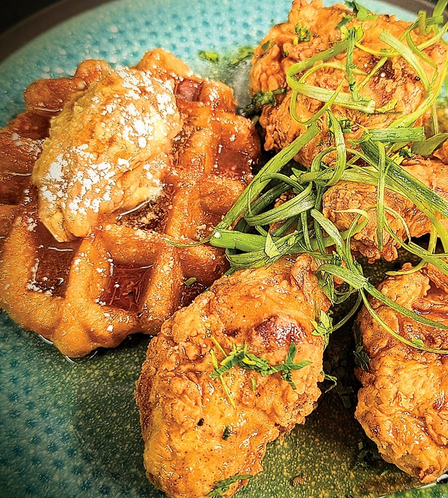 Crispy chicken and waffles, topped with scallions.