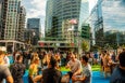 People gather at a beer garden among city skyscrapers.