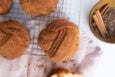 Bun-shaped pastries are covered with a dusting of light brown spices.