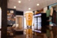 A pint of beer in a Rockport Brewing Co. branded glass sits on a glossy wood bartop.