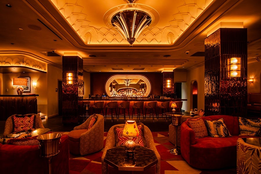 An upscale bar with lots of curved lines, reds, and golds.