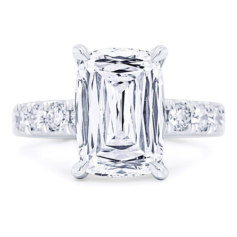 Platinum ring featuring a large rectangular radiant-cut diamond in a four-prong setting, with smaller round diamonds embedded along the band.