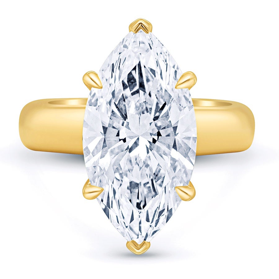 Gold ring featuring a large marquise-cut diamond held by six prongs. The band is smooth and polished with a rounded shape.