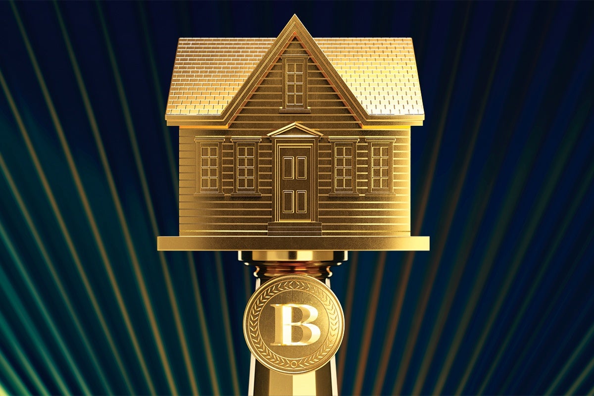 Golden house model with detailed windows and door, mounted on a pedestal featuring a circular emblem with the letter "B," set against a dark background with radiating light beams.
