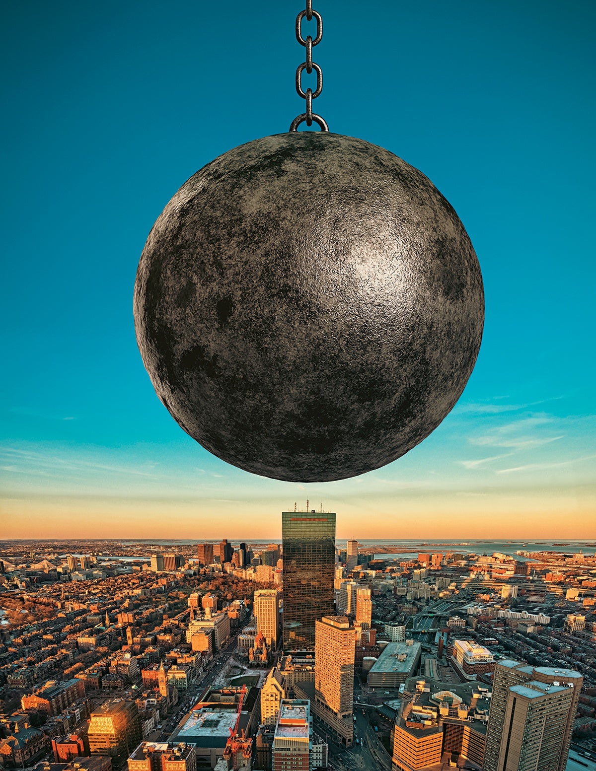 A large, textured wrecking ball suspended by a chain dominates the foreground above a cityscape at sunset, with tall buildings and a clear sky in the background.